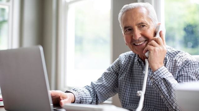 man on the phone with laptop